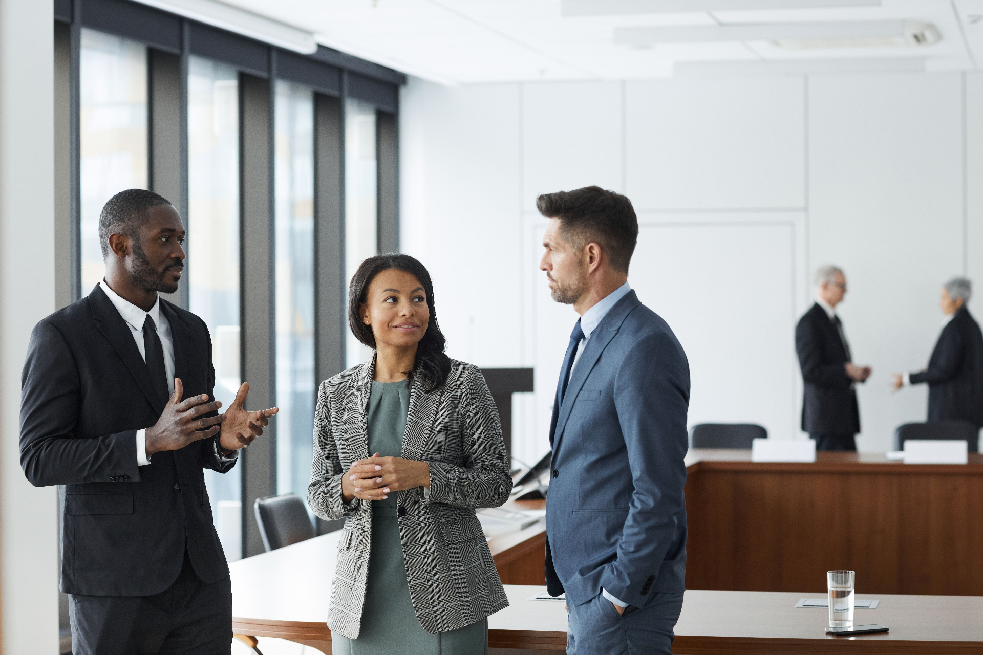 Business professionals walking together outside a modern glass office building